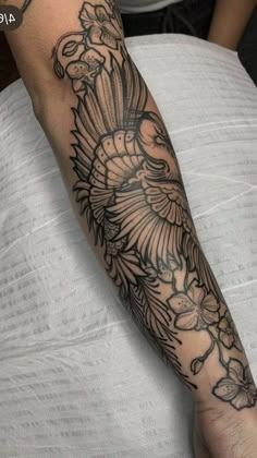 a person with a bird tattoo on their arm