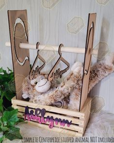 two stuffed animals sitting in a wooden hanger