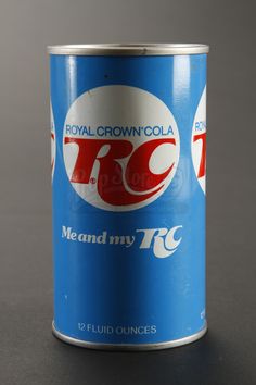 a can of royal crown cola sits on a table in front of a gray background