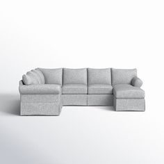 a large sectional couch sitting on top of a white floor