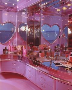 a pink vanity with three heart shaped mirrors