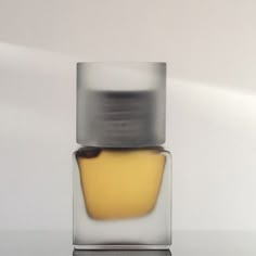 a glass container with a yellow substance in it