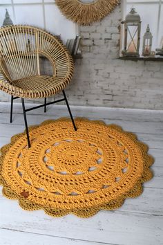 a yellow rug on the floor next to a wicker chair