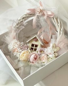 a white box filled with flowers and a small house