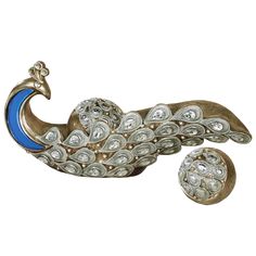 a silver and blue broochle on a white background