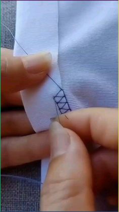 someone is stitching something with their hands