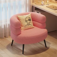 a pink chair with a skull pillow on it