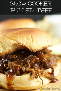 slow cooker pulled beef sandwich on a cutting board with text overlay that reads slow cooker pulled beef