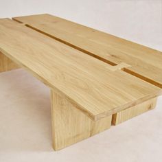 a wooden bench made out of wood on a white surface with no one around it