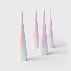 four white cone shaped objects on a gray background