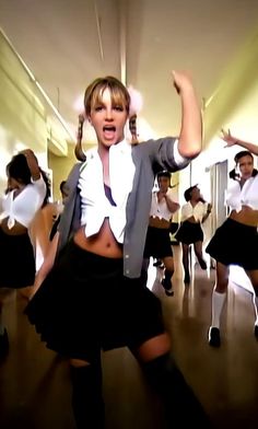 a group of young women dancing in school uniforms