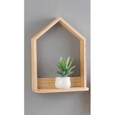 a wooden shelf with a potted plant on it