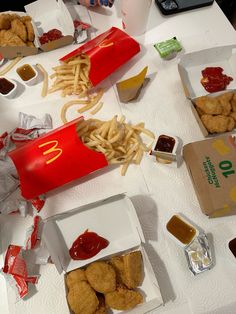 the table is full of fast food and condiments