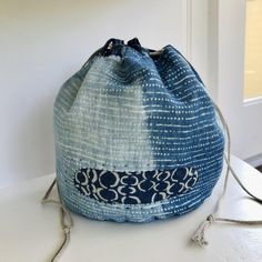 a blue and white bag sitting on top of a table