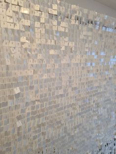 a white wall with lots of tiles on it