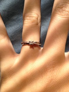 a woman's hand with two rings on it