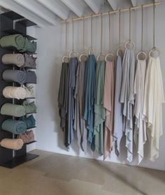 there are many folded towels hanging on the wall