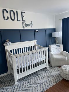 a baby's room with blue walls and white furniture