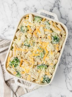 a casserole dish filled with broccoli and cheese