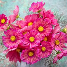 a vase filled with pink flowers on top of a table