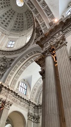 the inside of a building with columns and windows