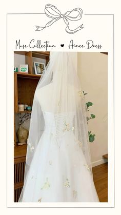 a white wedding dress with flowers on it