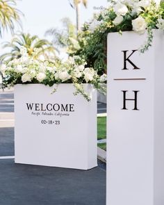 two large white boxes with flowers in them