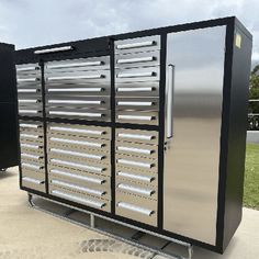 a large metal cabinet sitting on top of a sidewalk