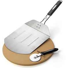 a cheese grater and spatula sitting on top of a cutting board with a knife