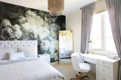 a bedroom with floral wallpaper and white furniture