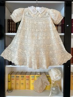 "A stunning and rare Christening set from the early 1900s.  It's a cream/tan colour and made of cotton Irish crochet interspersed with fine lace through the skirt and bodice.  Tiny crochet buttons at the rear neckline.  Short puff sleeves and a matching Irish crochet pouch (perhaps that was for the mother to carry). A silk bonnet edged in tiny ribbon and lace.   There's a white Swiss cotton petticoat to go under the Christening gown.  It's all so beautiful.  The underdress has the label 'The Whi Crochet Lace Dress For Wedding, Cream Lace Baptism Dress For Church, Cream Lace Dress For First Communion, Fitted Cream Lace Dress For Baptism, Cream Lace Patchwork Dress For Baptism, Cream Lace Dress With Lace Trim For Ceremony, Fitted Lace Baptism Dress In Off White, Vintage Cream Lace For Ceremonies, Cream Lace Trim Dress For Church