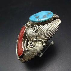 "VINTAGE NAVAJO RING DESCRIPTION: This spectacular ring features Sleeping Beauty turquoise and old red Mediterranean branch coral. The gemstones are secure in scalloped bezel, on a foundation of heavy gauge vintage sterling silver. Highly detailed applied leaves enhance the face of the ring. This impressive ring will be a treasured addition to your collection of fine vintage Native American jewelry. MEASUREMENTS: Ring face measures 2\" x 1 1/4\" Turquoise cabochon measures 20mm x 13mm RING SIZE: Vintage Red Gemstone Jewelry, Southwestern Style Red Ring Jewelry, Unique Red Multi-stone Turquoise Ring, Southwestern Multi-stone Red Ring, Southwestern Red Multi-stone Ring, Southwestern Style Red Turquoise Ring, Red Southwestern Multi-stone Rings, Retro Red Ring Jewelry, Vintage Red Rings