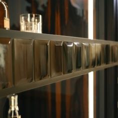 the reflection of bottles and glasses in a mirror