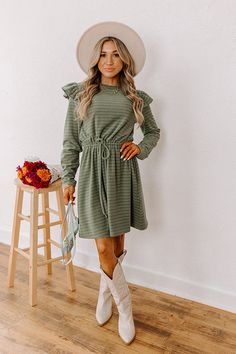 - Step out in charm with this darling mini dress! Featuring ruffled shoulders and a cinched waistline, it's perfect for effortless everyday elegance. - Unlined, ultra-soft material with a brown, blue, and green hued striped pattern - A crew cut neckline - Long sleeves with ruffled shoulder details - A functional drawstring to cinch the waist - Hidden side pockets - A relaxed yet flattering silhouette that ends in a straight mini dress length hemline Fall Button-up Mini Dress For Daywear, Fall Season Washed Button-up Dress, Casual Medium Wash Button-up Mini Dress, Striped Button-up Dress With Relaxed Fit, September Fashion, Concert Fashion, Sweater Jumpsuit, Essential Dress, Striped Mini Dress