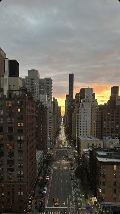 an aerial view of a city street at sunset