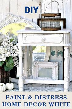 a white table with flowers and a mirror on it that says paint & distress home decor white