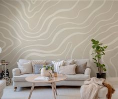 a living room filled with furniture and a wall painted in white waves on the wall