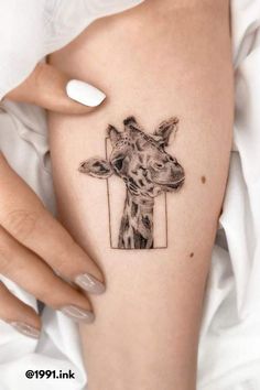 a giraffe tattoo on the right thigh