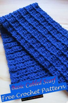 a blue crocheted scarf sitting on top of a wooden table next to a tag that says basic cabled scarf free crochet pattern