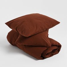 two brown pillows stacked on top of each other