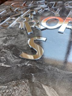 a close up of a metal sign on top of a marble table with the word stop written in large letters