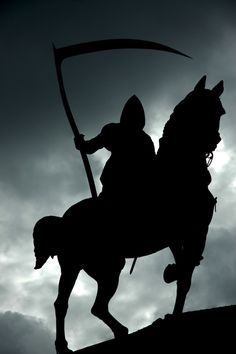 the silhouette of a man on a horse holding a spear