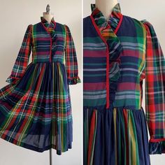 This is a festive handmade garment from the 1960's. The dress is in a lightweight organic material in a blue plaid pattern. The neckline, bodice, and wrist are trimmed with a red cord and ruffle. The dress looks to be handmade and shows no visible flaws. The dress is semi-sheer, and a slip would be recommended. The dress is in excellent condition.Measurements:Bust: 37" | Waist: 35" | Hips: Free | Shoulders: 14" | Sleeves" 23" | Length: 48"Unless otherwise stated all vintage items are used and ma Retro Plaid Dresses With Ruffles, Retro Plaid Dress With Ruffles, Vintage Lined Plaid Dress, Blue Plaid Pattern, Blue Plaid Dress, Handmade Dress, Vintage Gowns, Vintage Bridal, Holiday Wedding