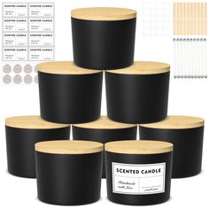 six black candle holders with wooden lids and labels on them, all in different sizes