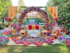 an outdoor ceremony with colorful decorations and flowers