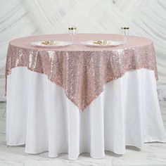 the table is covered with pink sequins and has two place settings on it