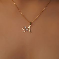 This is an exquisite initial diamond charm pendant set in 14K Solid Gold. An elegant design, perfect for regular wear featuring close set sparkling diamonds. ITEM DETAILS: ✓ Letter : M ✓ Gold Kt: Solid 14K Yellow Gold ✓ 14 K Gold Weight : 1.15 grams ✓ Diamond Shape/ Cut: Round Brilliant ✓ Diamond weight: 0.06 carats ✓ Diamond No.: 6 Natural Diamonds ✓ Diamond Color: I-J ✓ Diamond Clarity: SI ✓ Gross Weight: 1.16 grams >>The Gold purity is guaranteed and it comes with authentic 14K gold hallmark. M Diamond Pendant, Gold Chain With Letter Pendant, M Name Locket, Letter M Pendant, M Pendant Letter, Gold Pendent Designs, Gold Pendants For Men, Gold Pendent, Gold Initial Pendant