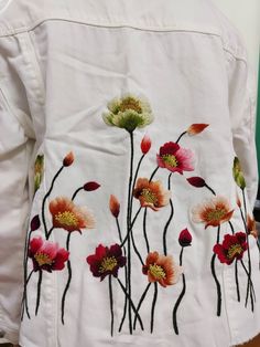 a white jacket with flowers painted on it