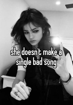 a girl is looking at her cell phone while she doesn't make a single bad song