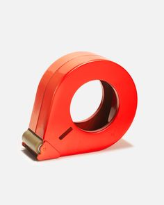 an orange tape dispenser on a white background